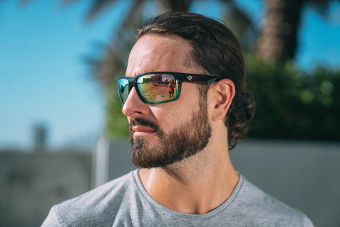 a man wearing Torege UV-resistant sunglasses in sunny summer outdoor setting